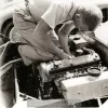 image for Bill Breeze wrestles with a Coventry Climax engine. Circa 1957. Photo credit Stephen Holman.