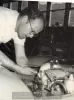 image for Nadeau "Nado" Bourgeault at work in his shop at the Sports Car Center in Sausalito, California. Circa 1957. Photo credit Stephen Holman.